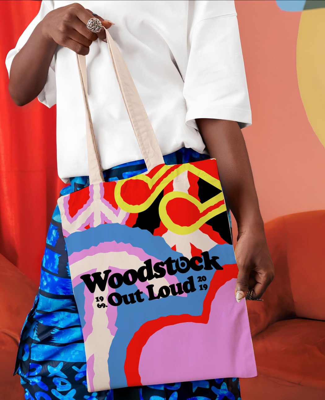 Tote bag in psychedelic pattern with Woodstock Out Loud wordmark